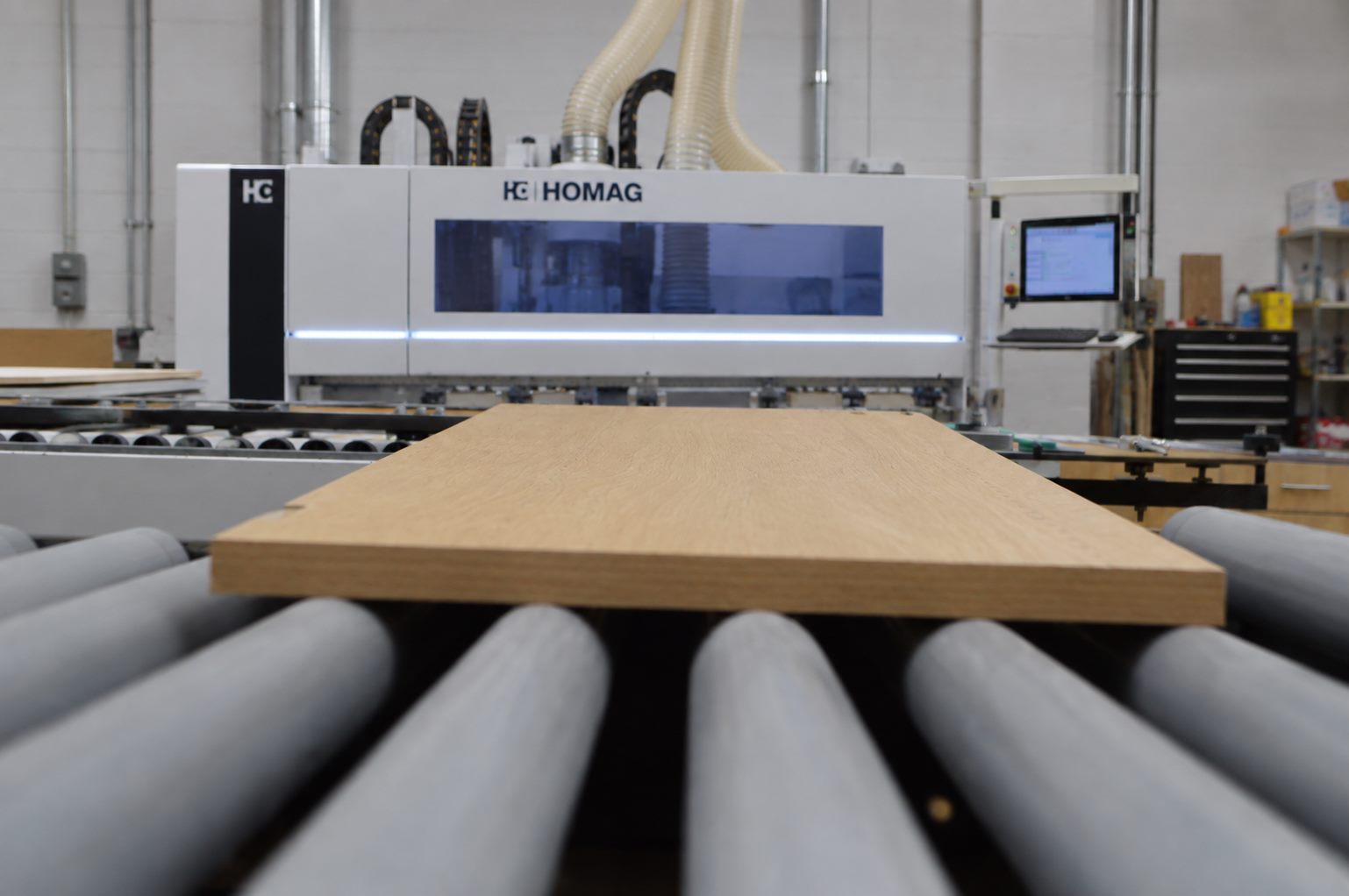 Edgebander applying PVC edge to a cabinet panel